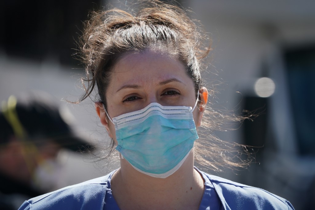 A member of the medical staff listens as Montefiore Medical Center nurses call for N95 masks and other �critical� PPE to handle the coronavirus (COVID-19) pandemic on April 1, 2020 in New York. - The nurses claim 
